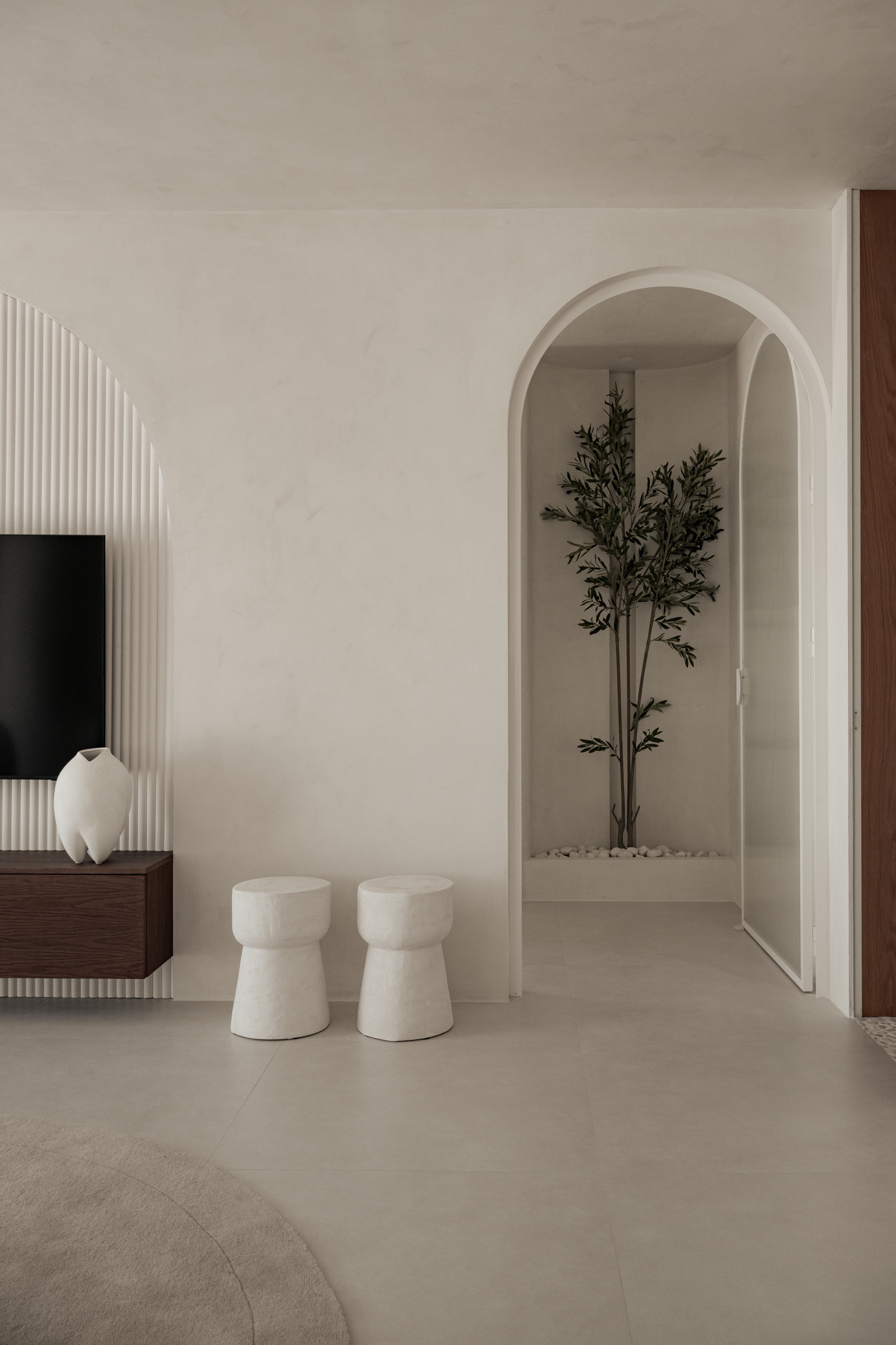 Oía Penthouse sculptural arch and living room detail
